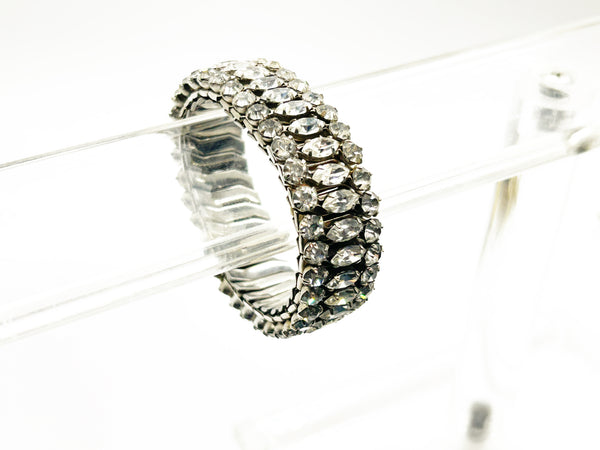 Sparkle up your vintage jewelry collection with this stunning three-row rhinestone bracelet expansion bracelet. Crafted in the classic style beloved from the 1940s through 1960s, this piece showcases brilliant clear glass rhinestones secured in a flexible silver-tone metal band. 
