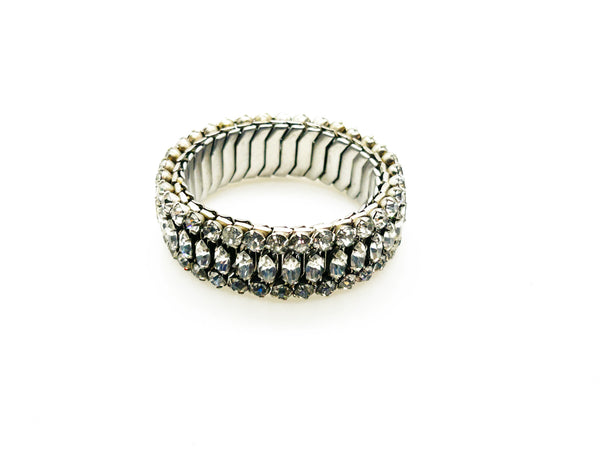 SSparkle up your vintage jewelry collection with this stunning three-row rhinestone bracelet expansion bracelet. Crafted in the classic style beloved from the 1940s through 1960s, this piece showcases brilliant clear glass rhinestones secured in a flexible silver-tone metal band. 