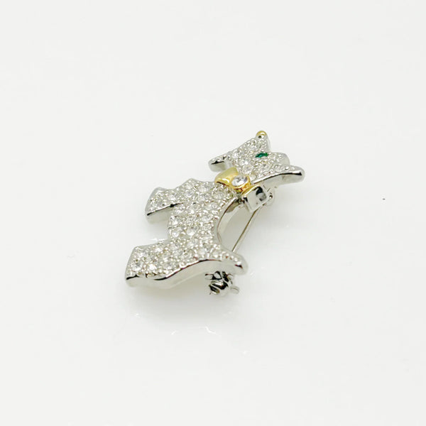 This brooch may be small in size, but is big on sparkle. Add a dash of canine charm to your outfit with this adorable vintage terrier brooch! This pint-sized pup brings major bling factor with its dazzling coat of pave set white rhinestones that catch the light with every movement. With its cheerful green eye that seems to wink at admirers, this petite (1.5" across) pin brings personality to any ensemble.