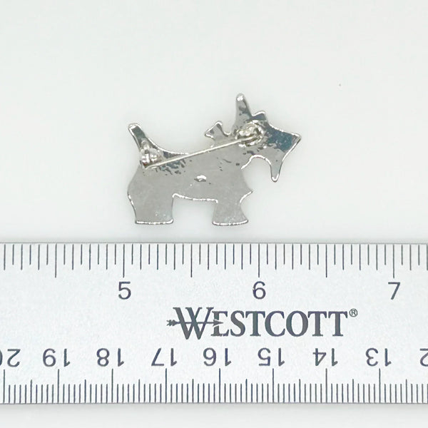 This brooch may be small in size, but is big on sparkle. Add a dash of canine charm to your outfit with this adorable vintage terrier brooch! This pint-sized pup brings major bling factor with its dazzling coat of pave set white rhinestones that catch the light with every movement. With its cheerful green eye that seems to wink at admirers, this petite (1.5" across) pin brings personality to any ensemble.