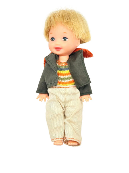 Vintage boy doll with blonde hair, rainbow sweater, and corduroy pants, collectible toy