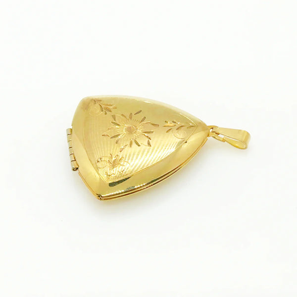 Showcase cherished memories in luxurious style with our Vintage Gold Filled Triangular Scrollwork Locket. With its exclusive triangular design and intricate floral engravings, it's an exquisite statement piece. 