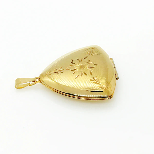 Showcase cherished memories in luxurious style with our Vintage Gold Filled Triangular Scrollwork Locket. With its exclusive triangular design and intricate floral engravings, it's an exquisite statement piece. 