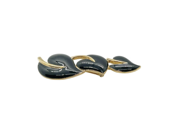 Meet your new favorite accessory! This gorgeous Trifari brooch showcases three beautifully crafted black enamel leaves accented with warm gold-tone metal—a timeless design from the 1980s-1990s era.