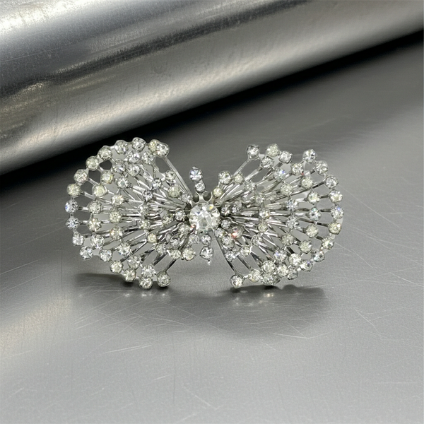 Perfect for vintage jewelry lovers: our Sparkling Vintage Atomic Silvertone Rhinestone Pin provides layered brilliance and a unique, eye-catching look. Shop today!