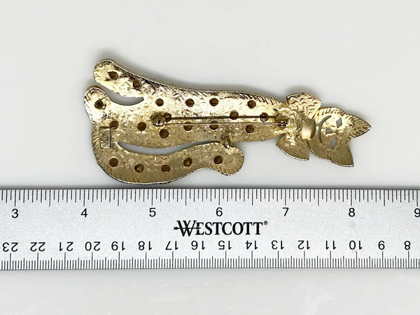 Get ready to add some playful pizzazz to your outfit with this tall kitty cat brooch! Measuring 4 1/2" tall, this gold tone cutie is signed Ultra Craft and studded with bright white rhinestones.