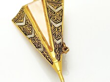 Vintage Spanish Damascene umbrella brooch with gold-tone filigree canopy panels, detailed red and black enamel patterns, a triangular mother of pearl inlay, and a dangling gold chain with a teardrop faux pearl charm against a plain white background