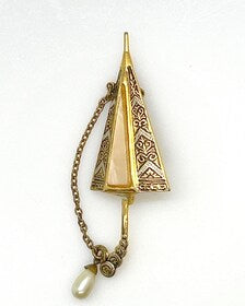 Vintage Spanish Damascene umbrella brooch with gold-tone filigree canopy panels, detailed red and black enamel patterns, a triangular mother of pearl inlay, and a dangling gold chain with a teardrop faux pearl charm against a plain white background