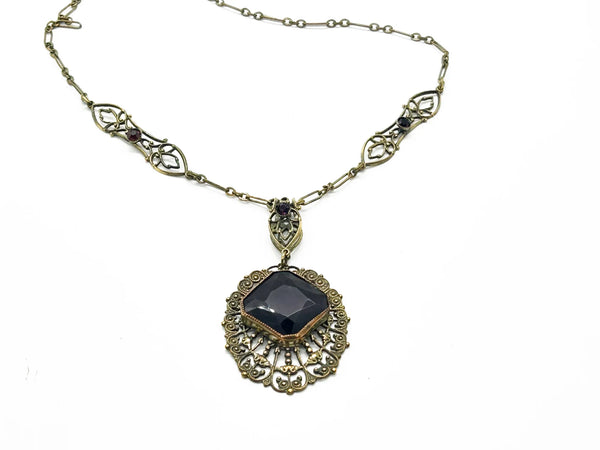 Enhance your jewelry collection with this one-of-a-kind standout piece. Adorned with intricate filigree and glistening purple stones, this necklace exudes elegance and charm. The centerpiece, a stunning diamond-shaped violet stone set in an ornate oval frame, adds a touch of luxury to any outfit