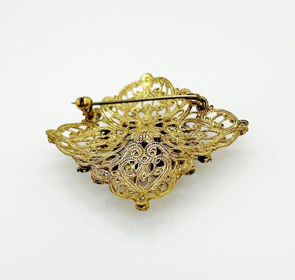 Intricate Vintage Gold Tone Brooch with Ruby Red Stones - Add timeless charm with this ornate brooch featuring deep ruby red stones. Perfect statement piece. Shop now!
