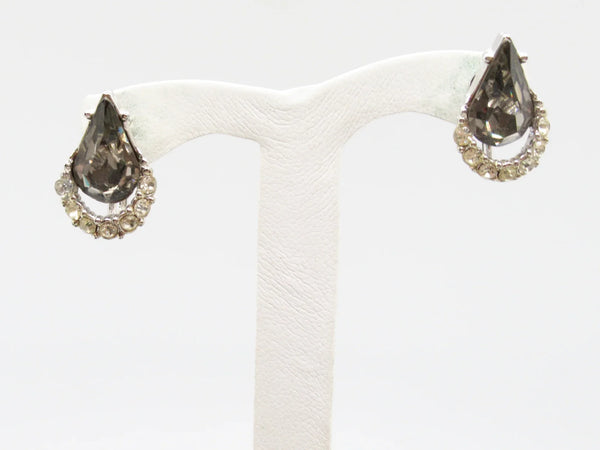 Get ready to shine with these stunning earrings from Weiss! Made with beautiful gray teardrop rhinestones, accented with sparkling clear round rhinestones, and set in high-quality silvery metal, these earrings are sure to make a statement. 