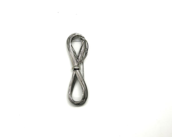 A silver-toned multi-strand wire bow brooch, featuring an infinity-shaped loop silhouette cinched with a smooth central band, displayed against a plain white background.