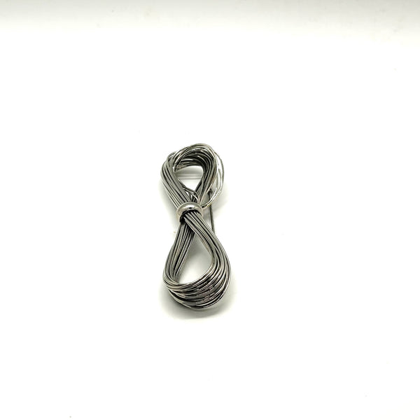 A silver-toned multi-strand wire bow brooch, featuring an infinity-shaped loop silhouette cinched with a smooth central band, displayed against a plain white background.