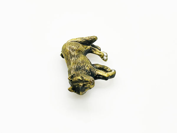Antiqued bronze wolf brooch pin with highly detailed textured fur on a plain white background