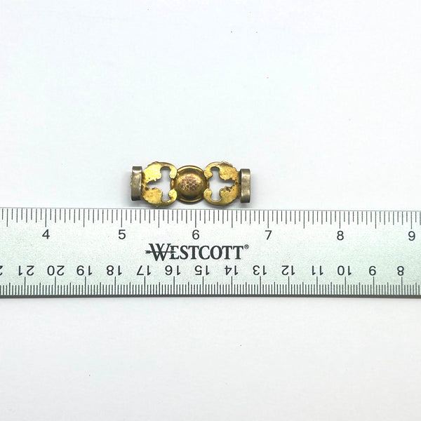 Antique Victorian monogrammed watch slide in gold-tone metal. Features a round hand-engraved monogram center and highly detailed repoussé scrollwork side accents, perfect as a jewelry making component